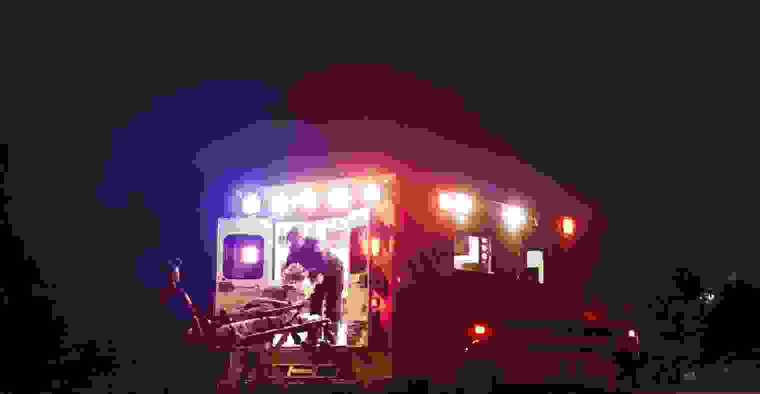 A woman being loaded into an ambulance.