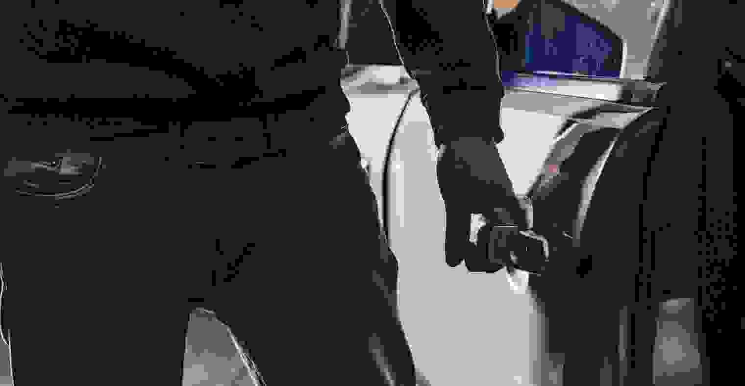 Man stealing a car at night