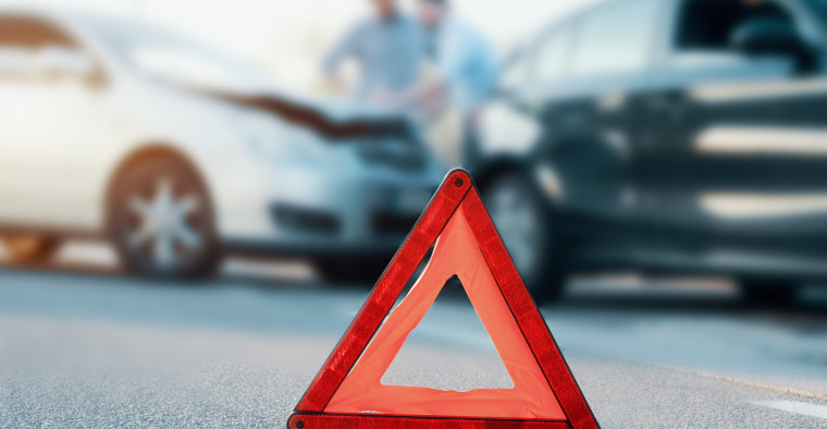 Two men reporting a car crash for insurance claim