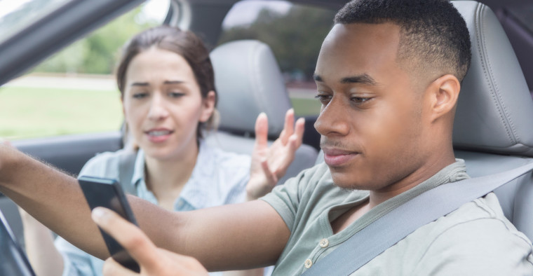 Couple in car on phone