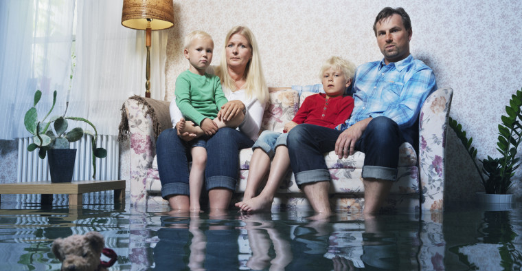 Family sitting in flooded basement