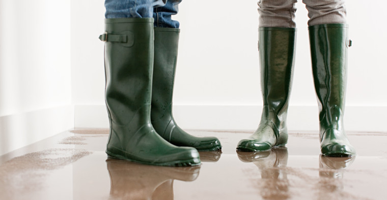people standing in flooded home