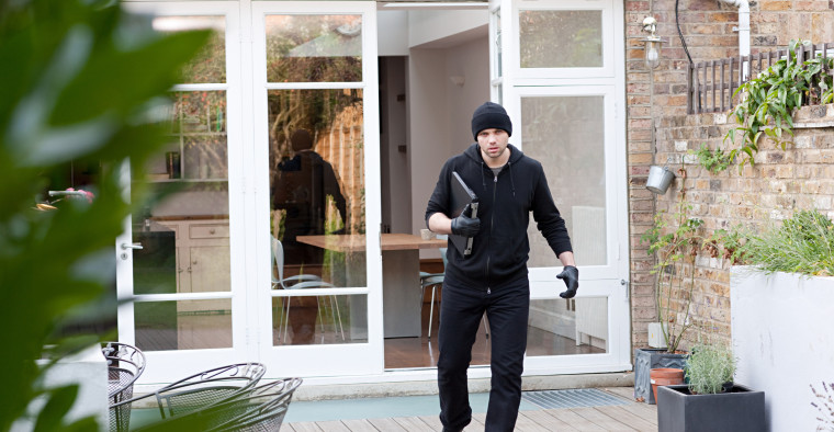 Thief stealing a laptop from a rented apartment