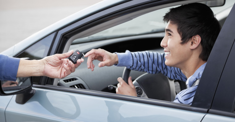Woman handing man a key fob