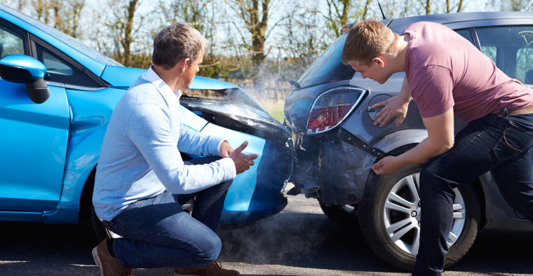drivers inspecting accident damage