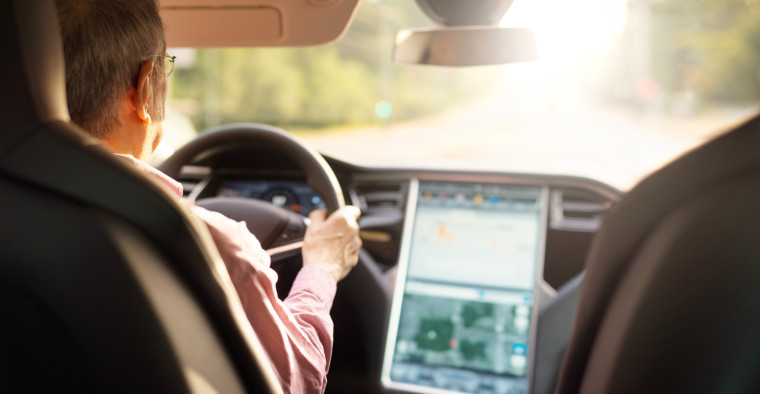 man driving a Tesla