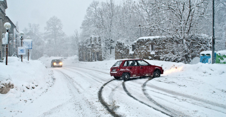 Car slides into snow bank