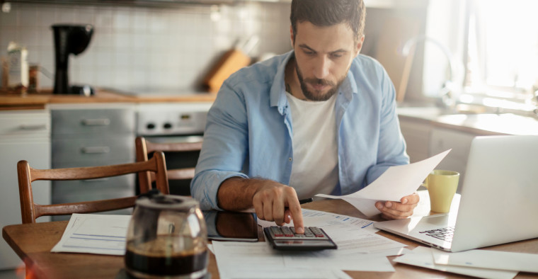 Man Calculating Personal Loan Interest