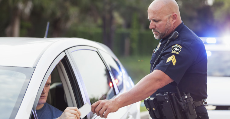 police officer reviewing driver's insurance