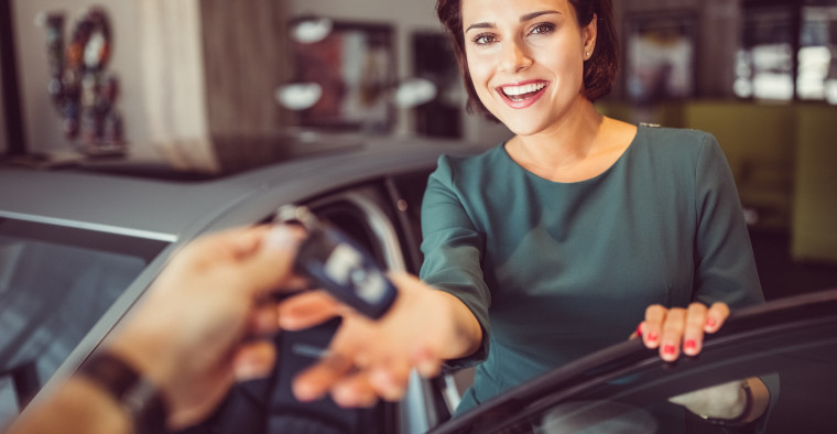 woman handing over car keys