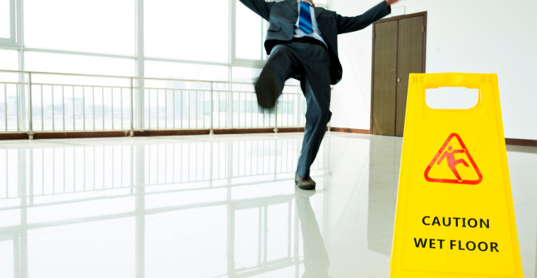 man slipping on wet floor