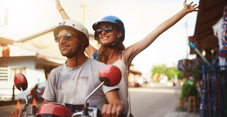Couple Riding a Scooter