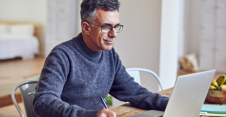 Shot of a handsome and mature businessman working from home