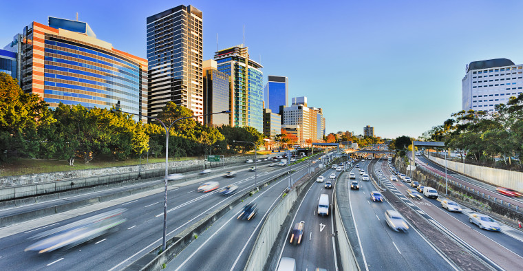 Wide view of multi lane Warringah freeway going through North Sydney during morning rush hour traffic peak and congestion in Australia.