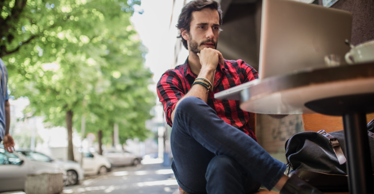 man using laptop in cafe health insurance discount
