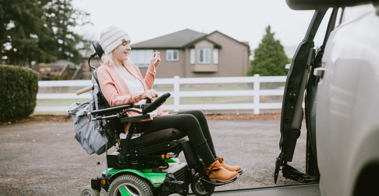 Woman in wheelchair getting in disability-adapted van
