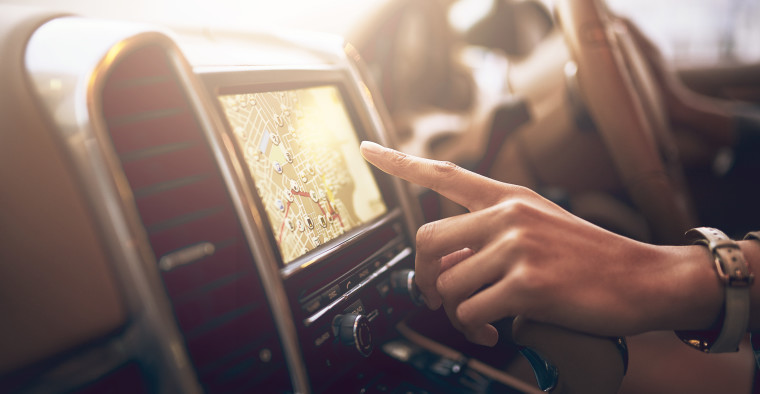 Woman touching navigation screen in car