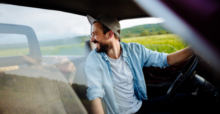 Young man driving on a farm