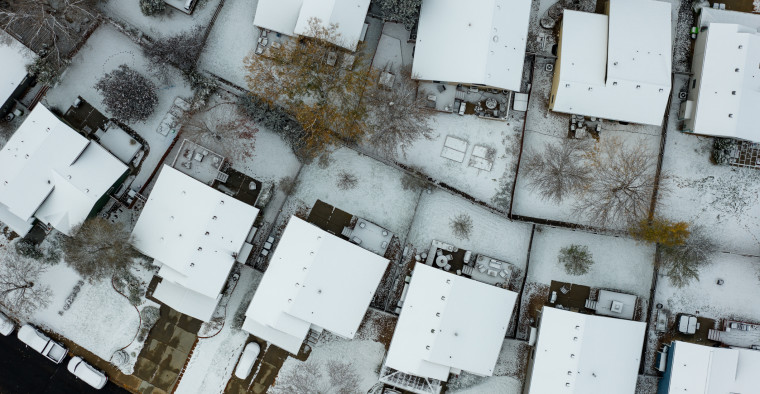 An aerial view of a snowy neighborhood