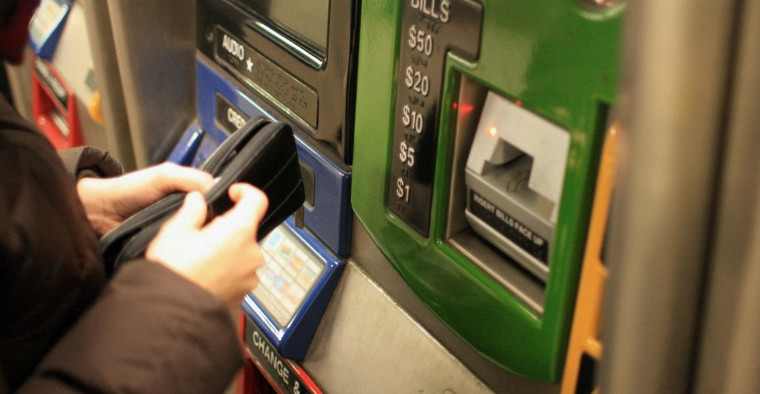 person buying metrocard to commute