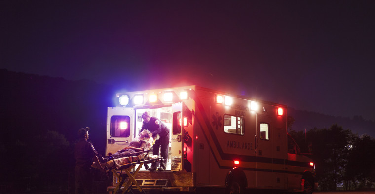 A woman being loaded into an ambulance.
