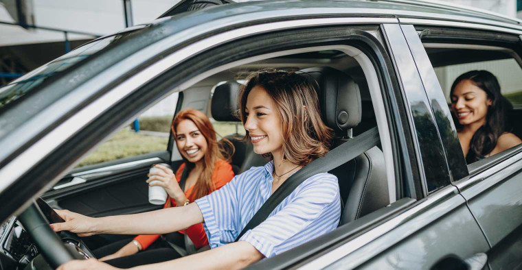 Friends sitting in the back of a car