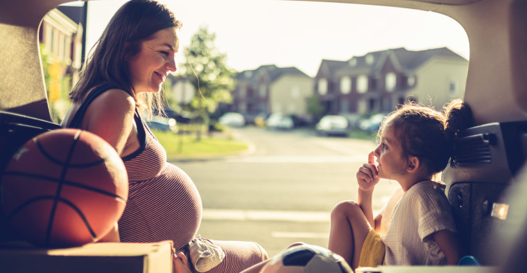 mother and daughter sitting in SUV