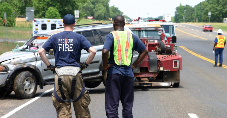 First responders arriving at the scene of a car crash.