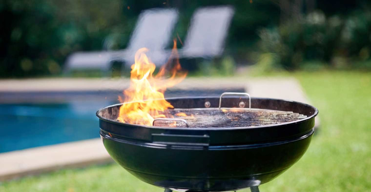 Charcoal grill in a backyard.