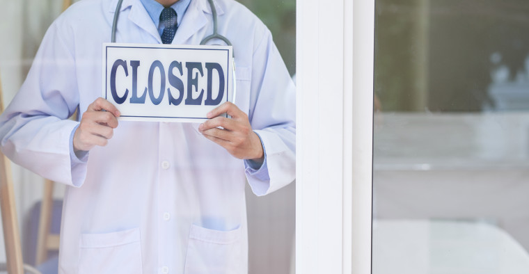A pharmacist closing his store