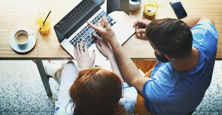 Couple looking at computer.