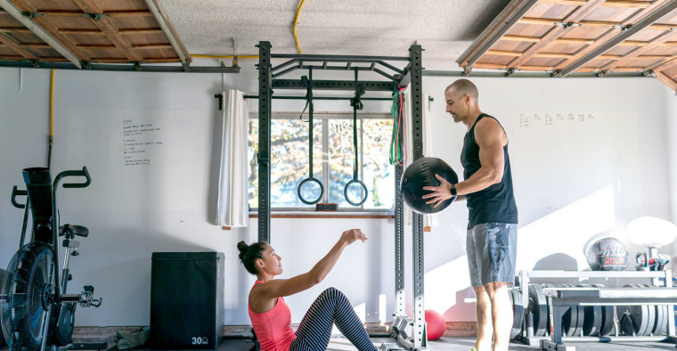 A couple exercises in their home gym.