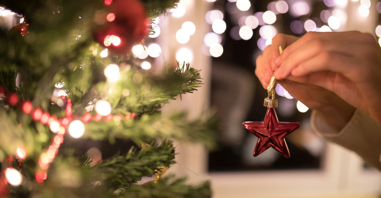 Decorating a Christmas tree.