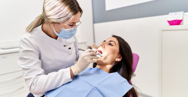A patient receives a dental checkup.