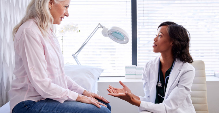 A doctor speaks to a patient.