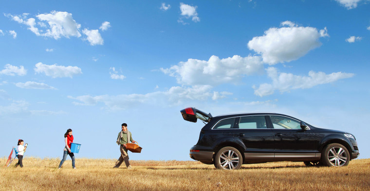 A family loading up their car.