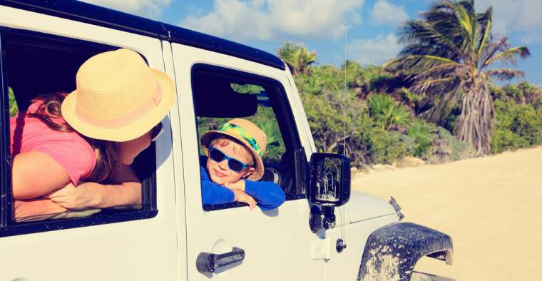family driving car to beach