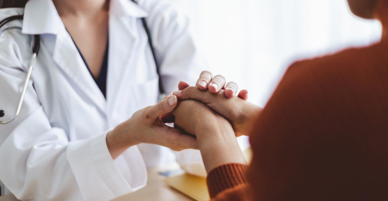 Doctor holding patient's hands