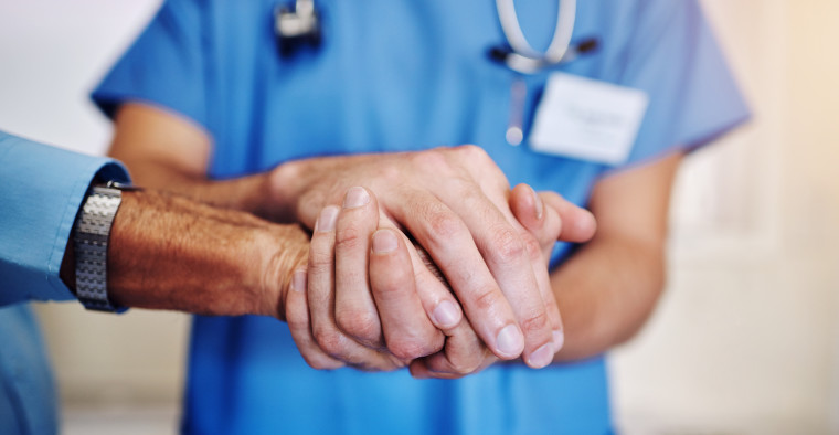 Doctor holding patient's hands