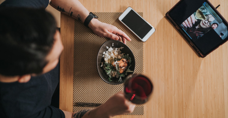 A person enjoying a virtual holiday dinner.
