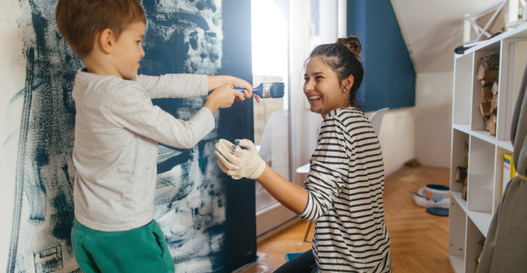 Mother and son painting bedroom