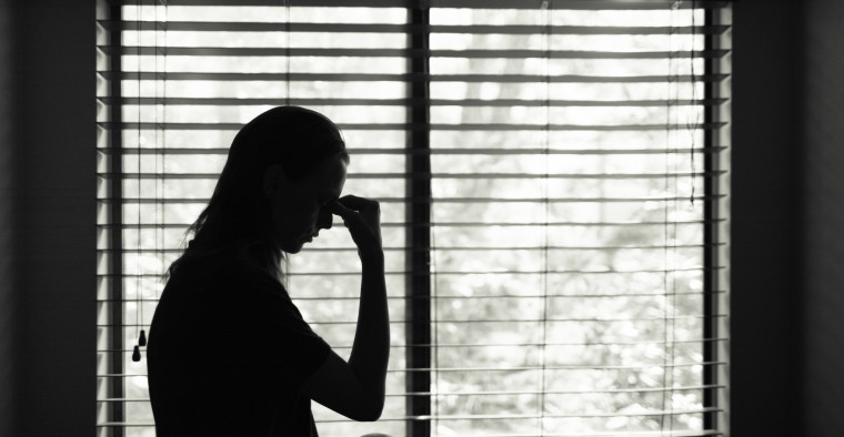 Lonely woman in window.