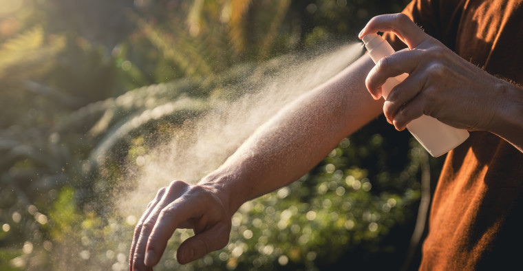 Man applying insect repellent