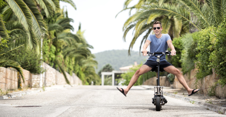 Man riding motorized scooter somewhere in Florida