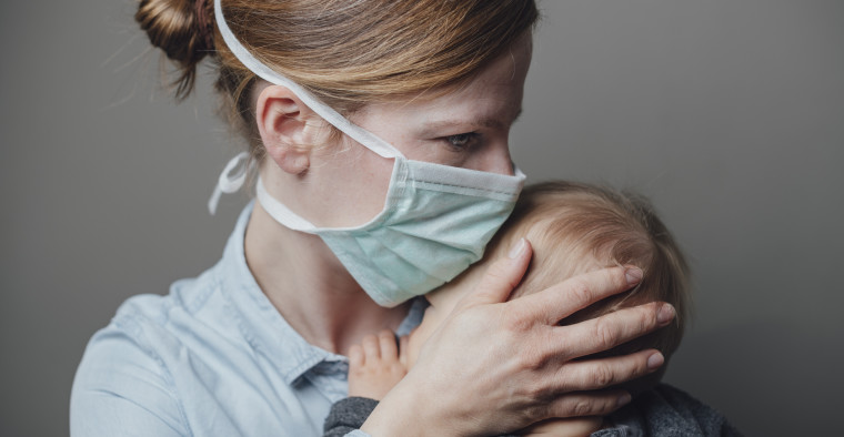 Mom wearing a facemask with her baby