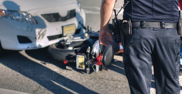A first responder at the scene of a motorcycle accident.