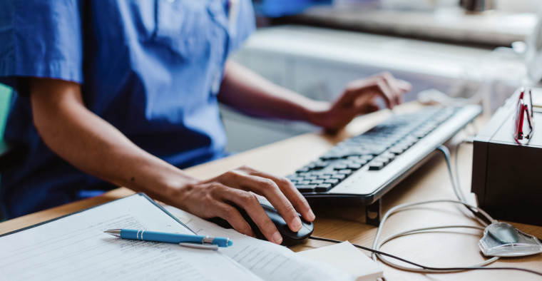 A nurse uses a hospital computer.