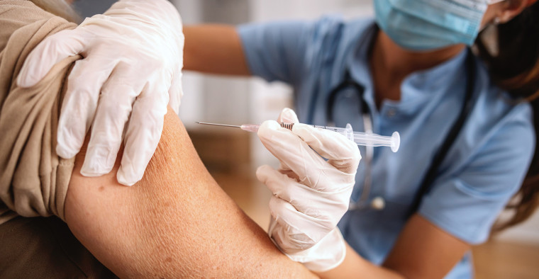 A nurse administers a flu vaccination.