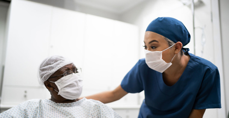 A nurse talking to a patient.