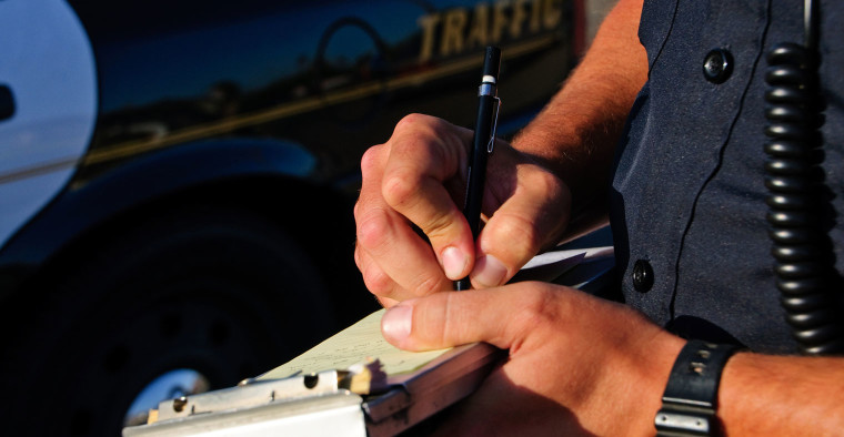 officer writing ticket